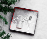 the perfect gift set on snow by a christmas tree