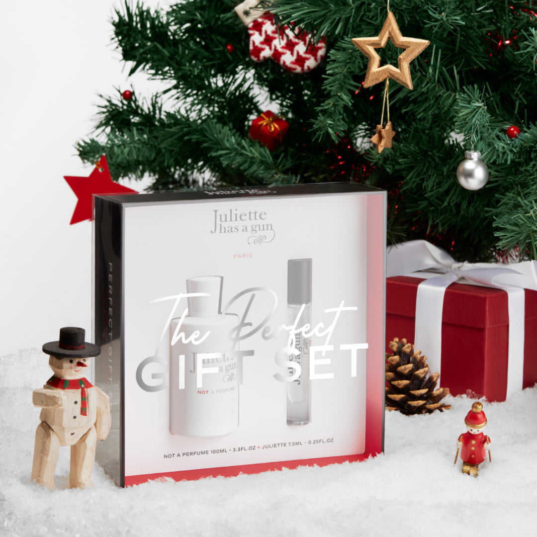 the perfect gift set by Juliette has a gun under a christmas tree with presents 